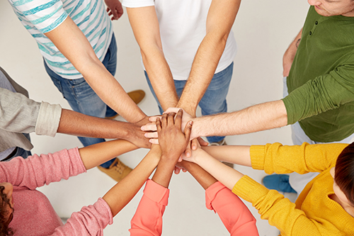 Hands together in a pile